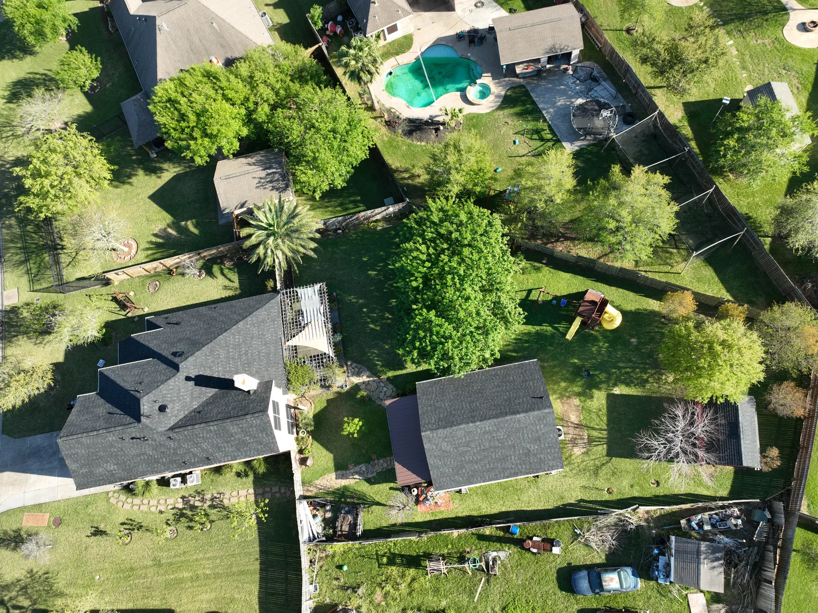 Overhead view of a finished roof and the surrounding property