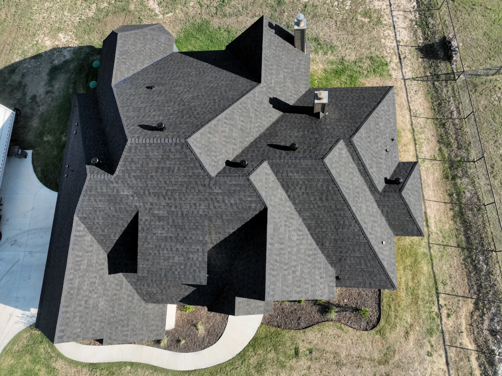 Overhead view of a shingle roof with multiple roof slopes